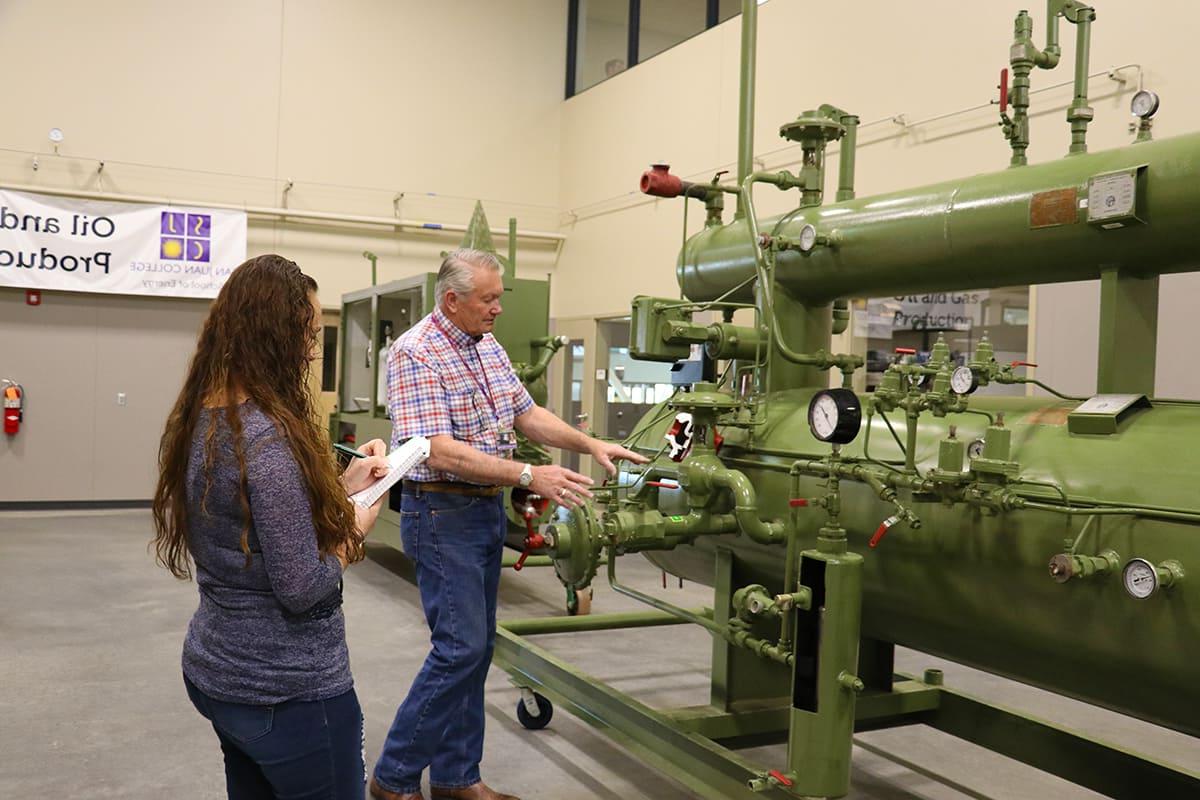 Instructor goes over program equipment with student explaining the processes of the large separator.